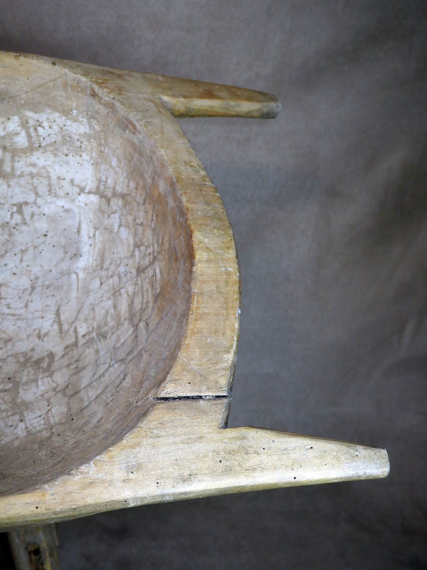Wooden dough bowl on a dark background