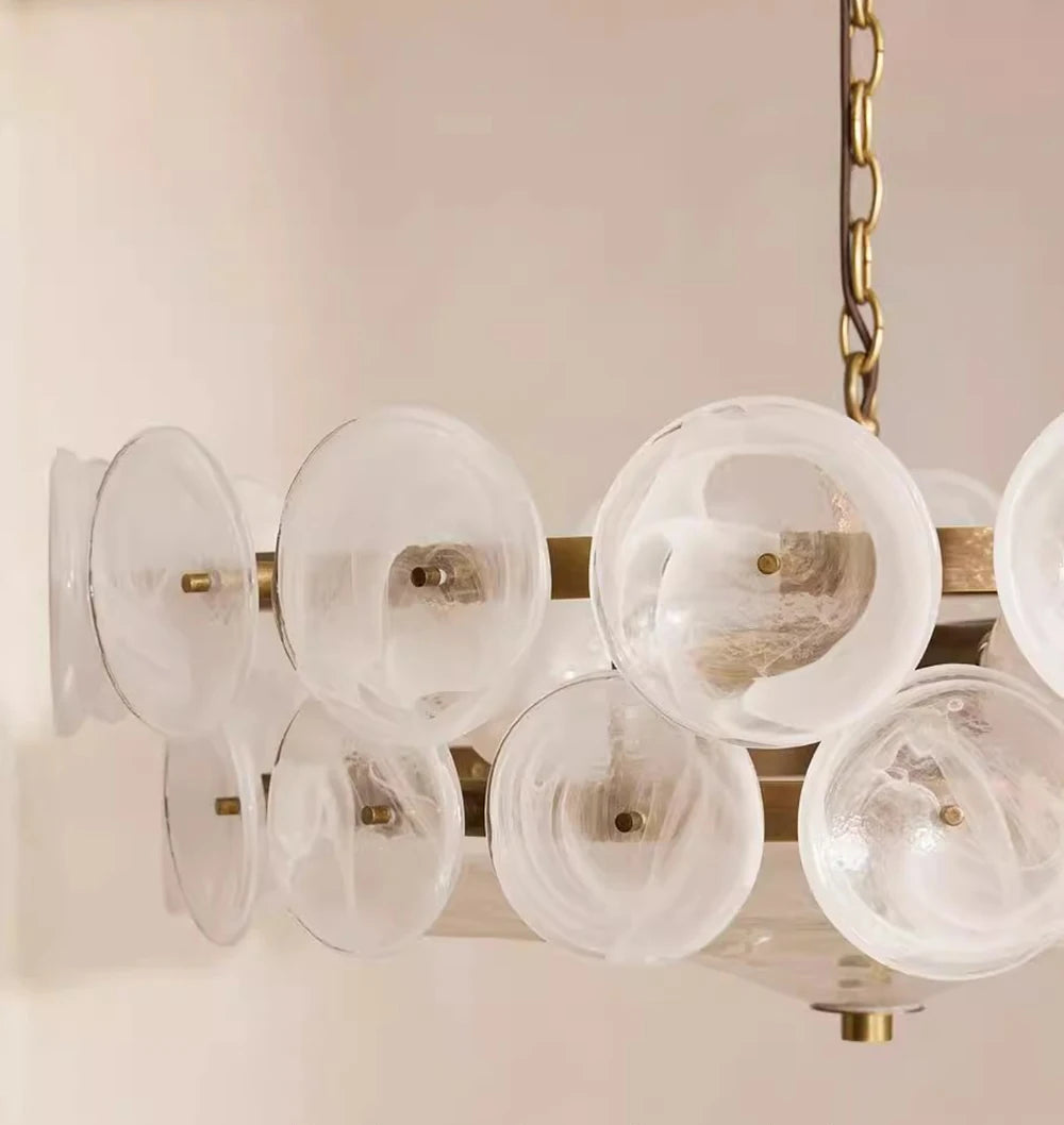 Chandelier with milk white glass lamp shades on a light pink background