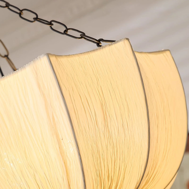 Close-up of cotton lampshade with a chain on a neutral background