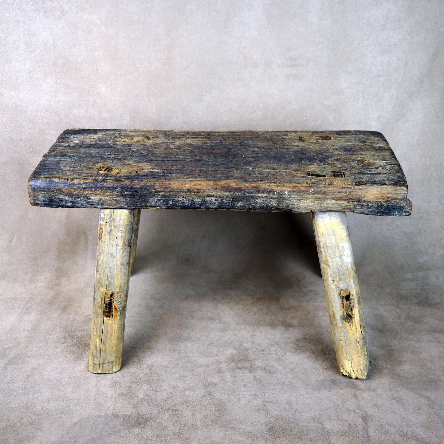Vintage wooden bench with a rustic appearance on a plain background