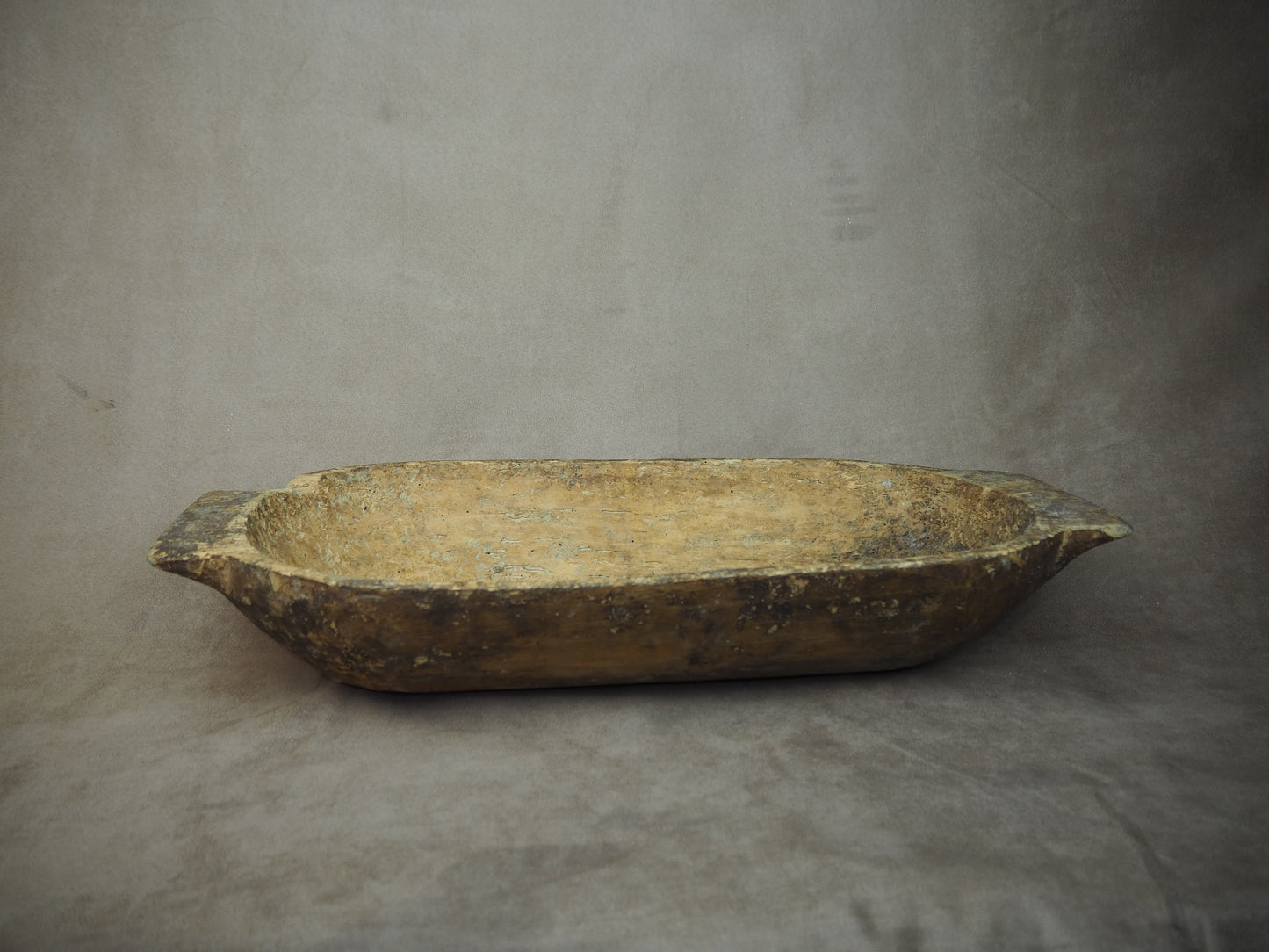 Vintage wooden dough bowl on a gray background