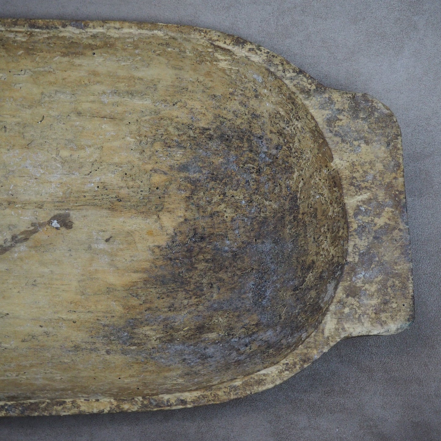 Weathered wooden bowl on a gray background