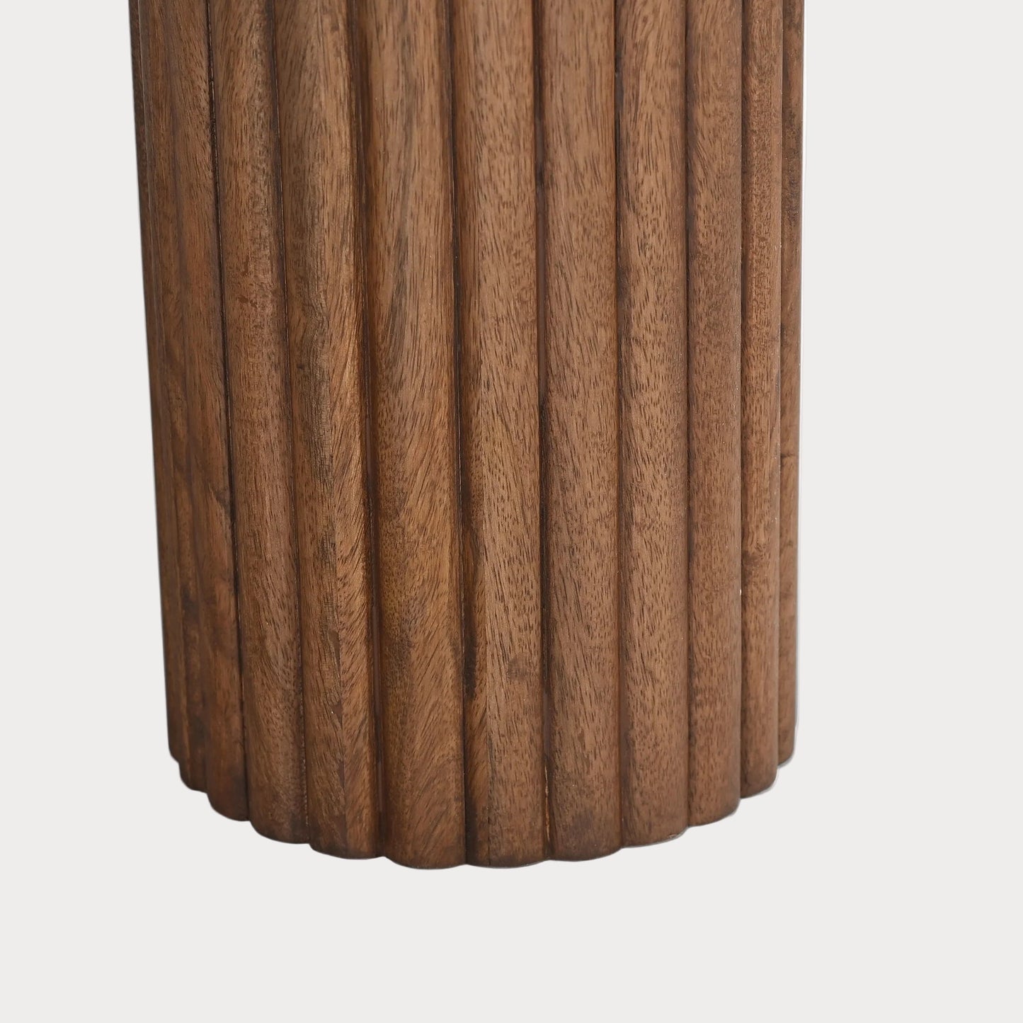 Wooden cylindrical object with a ribbed texture on a white background