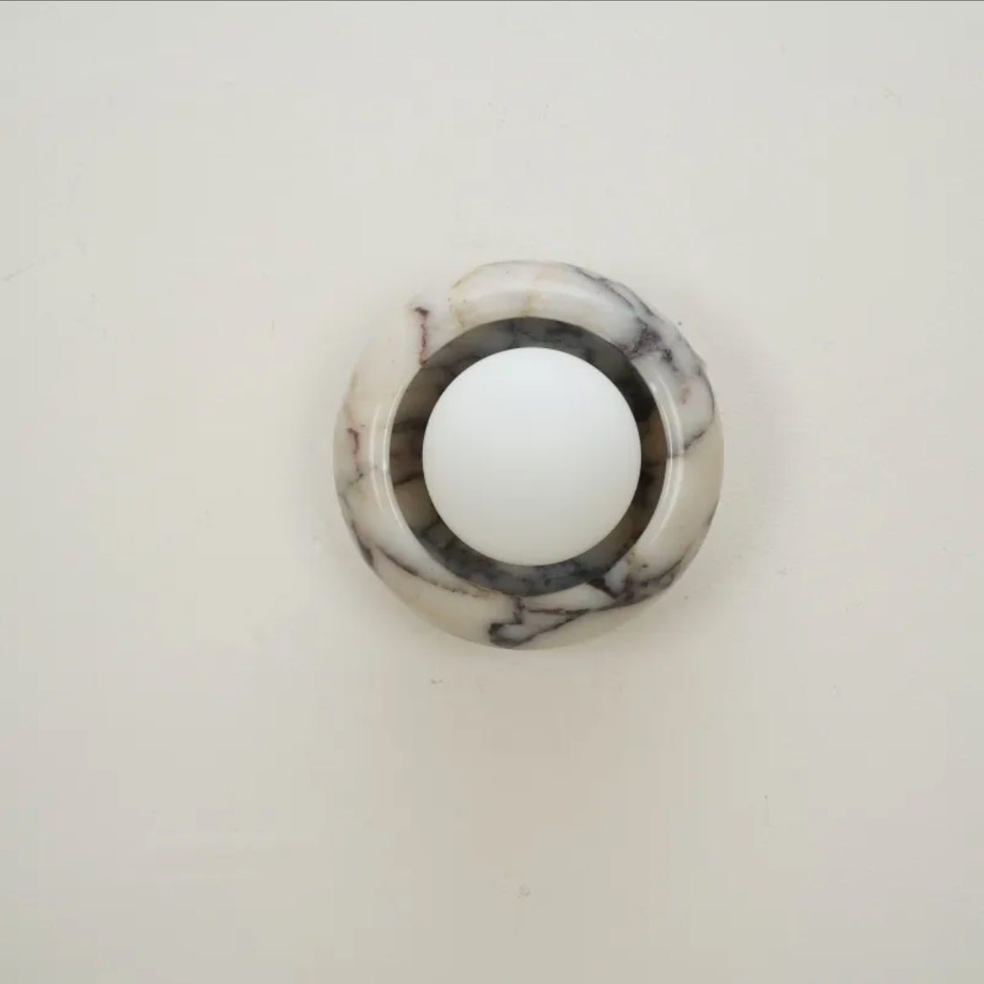 Round marble light on a white background