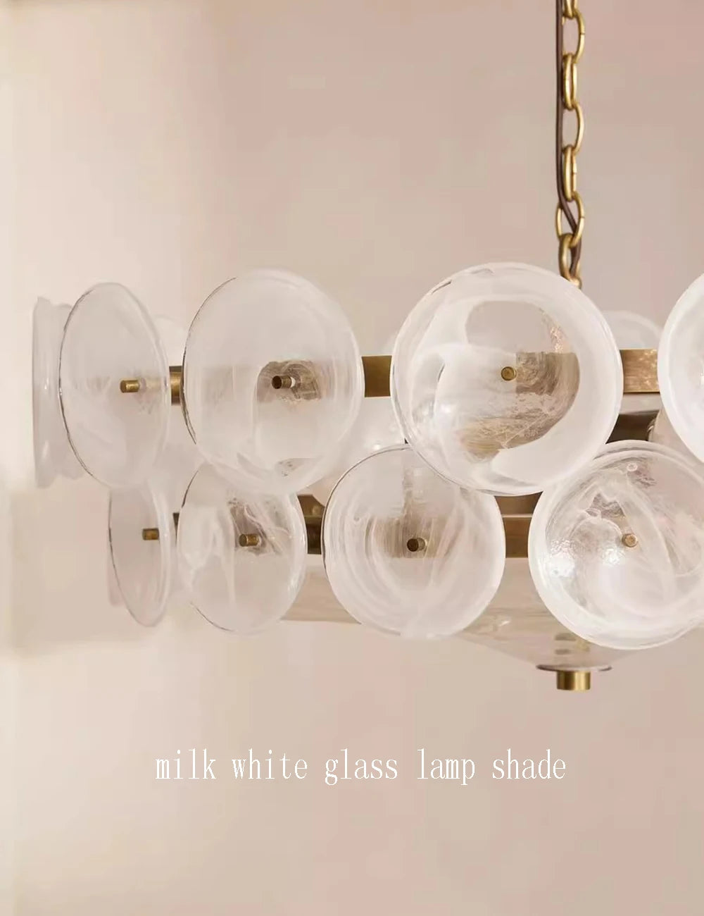 Chandelier with milk white glass lamp shades on a light pink background