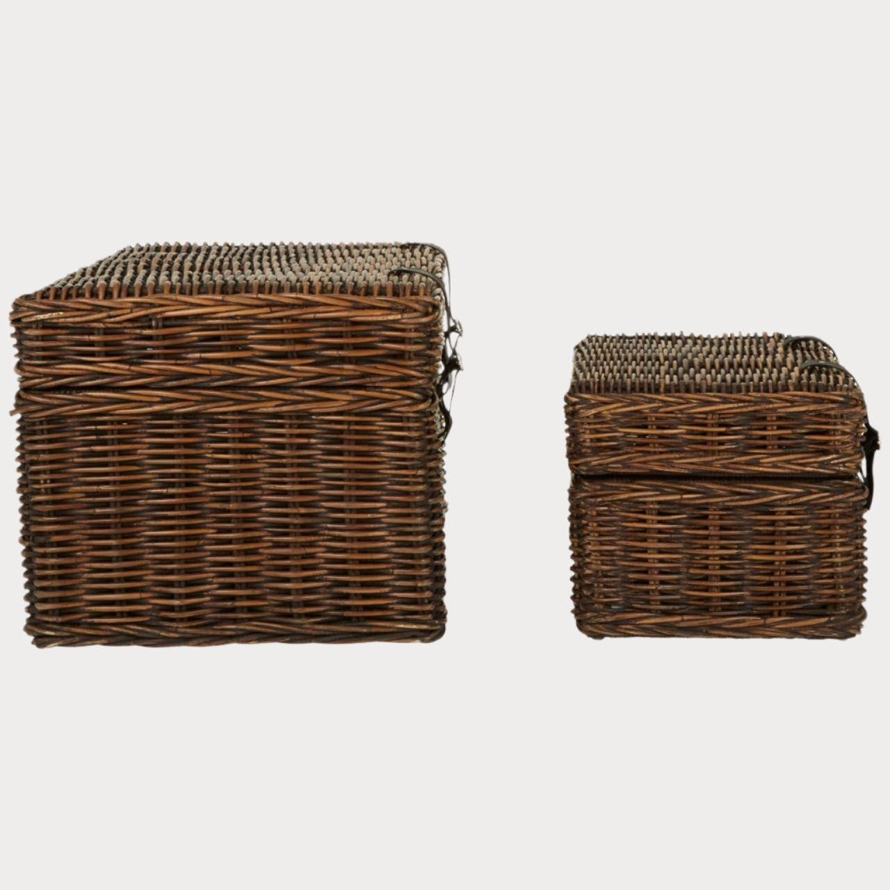 Two brown wicker storage baskets on a white background