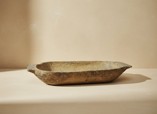 Vintage wooden dough bowl on a gray background