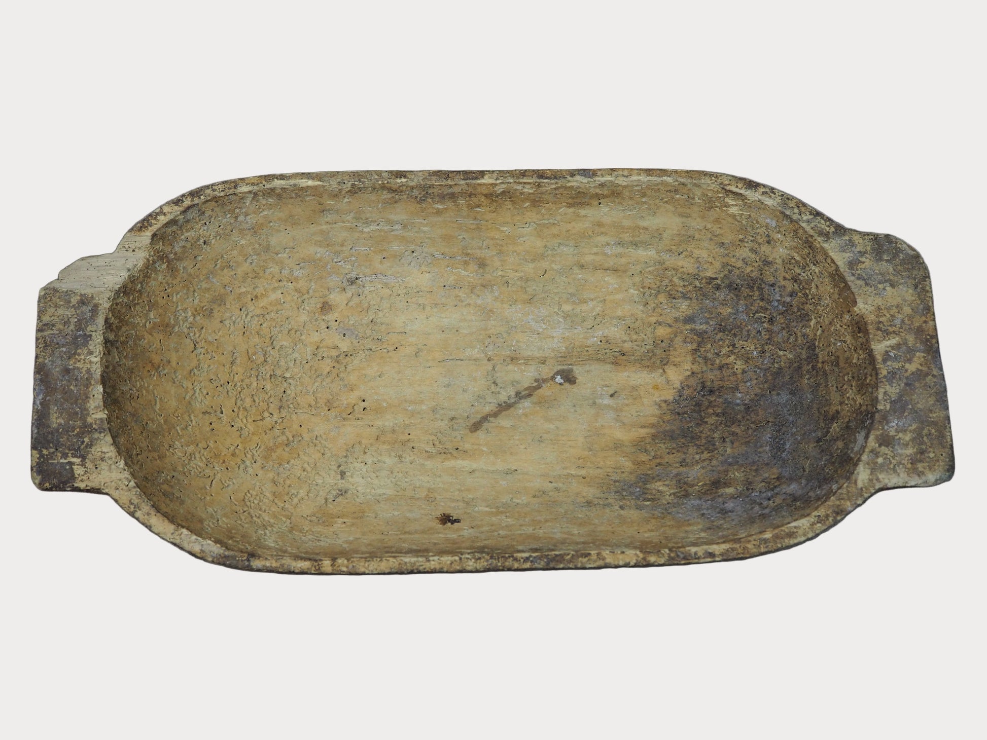 Rectangular wooden dough bowl with a worn surface on a gray background
