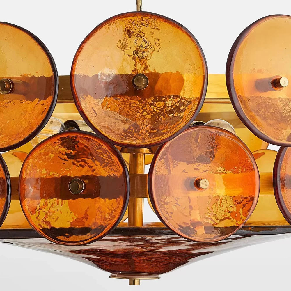 Decorative wall light fixture with amber glass shades on a white background