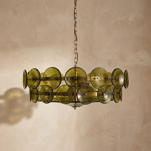 Green chandelier hanging against a beige wall