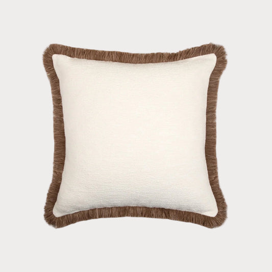 White pillow with brown fringed trim on a white background