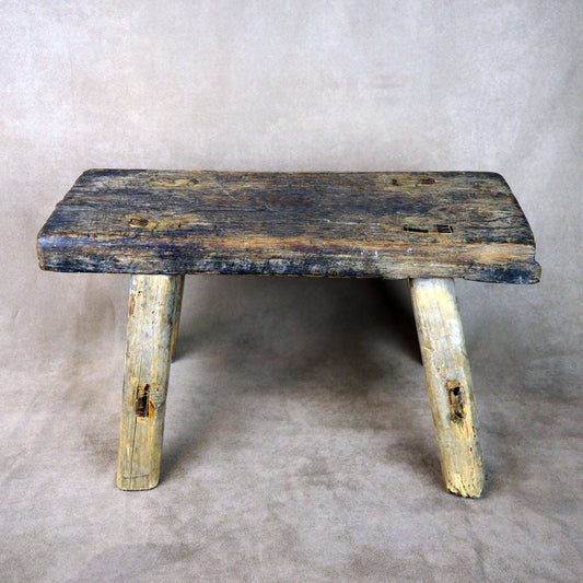 Vintage wooden bench with a rustic appearance on a plain background