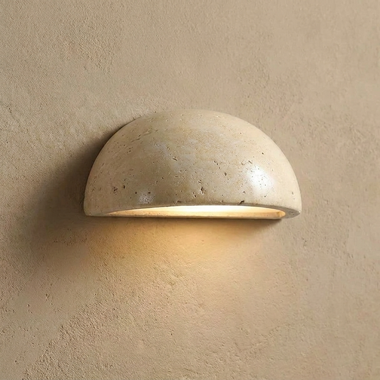 Travertine wall light fixture on a beige wall