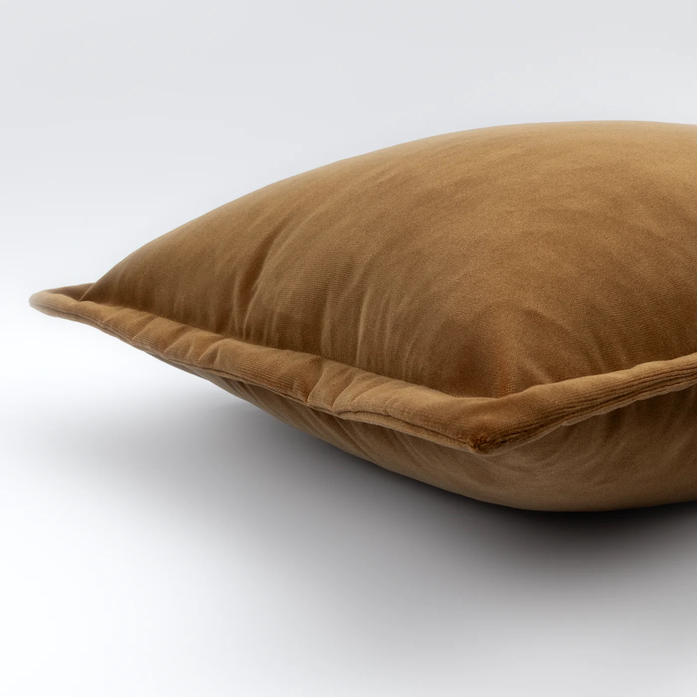 Brown velvet pillow on a white background