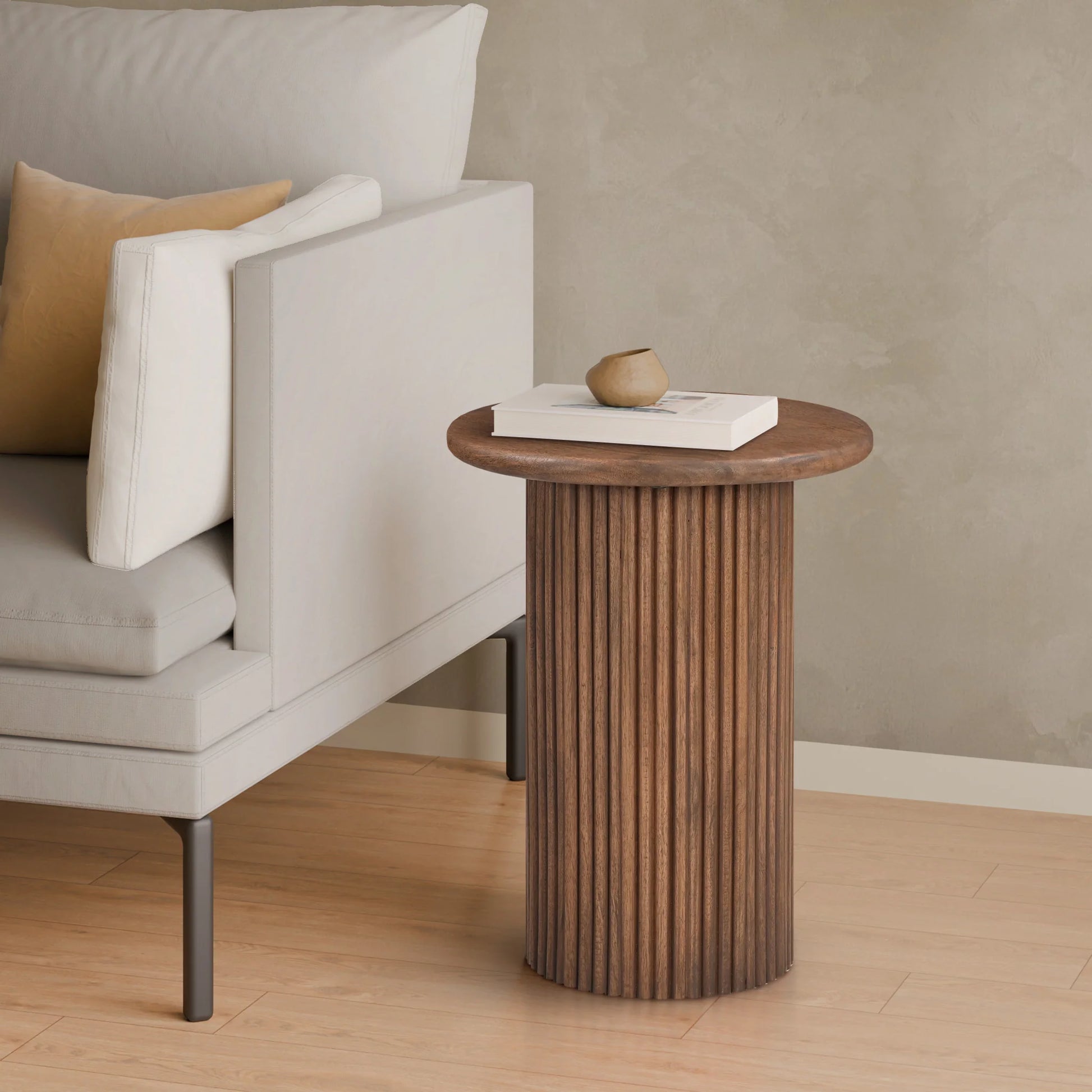 Wooden side table next to a gray sofa with a beige pillow