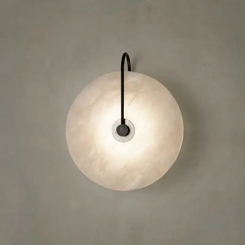 ORBIT | Circular sconce with black detailing.