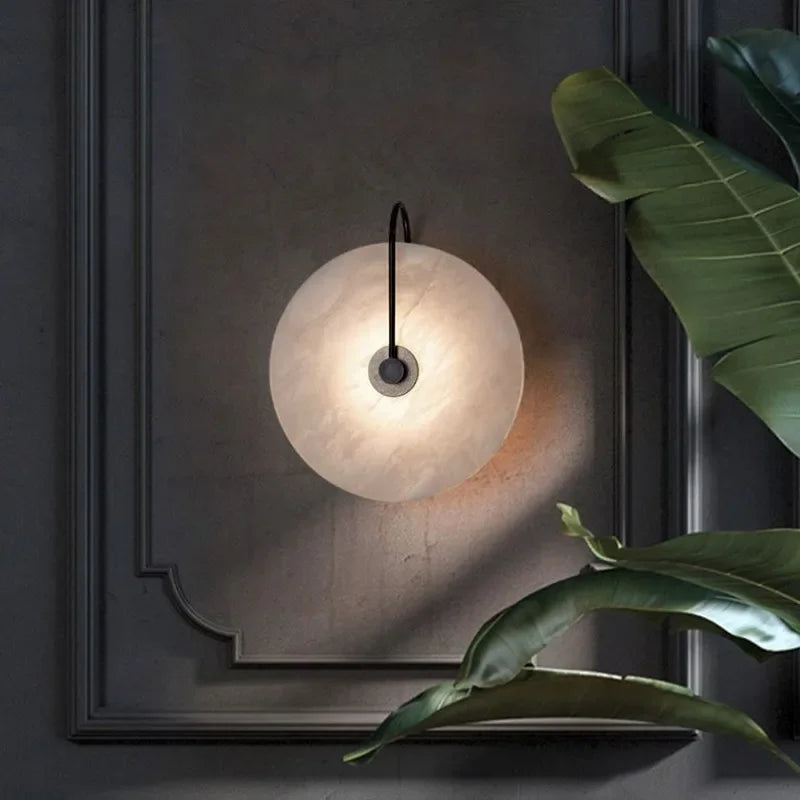 ORBIT | Circular sconce with black detailing.