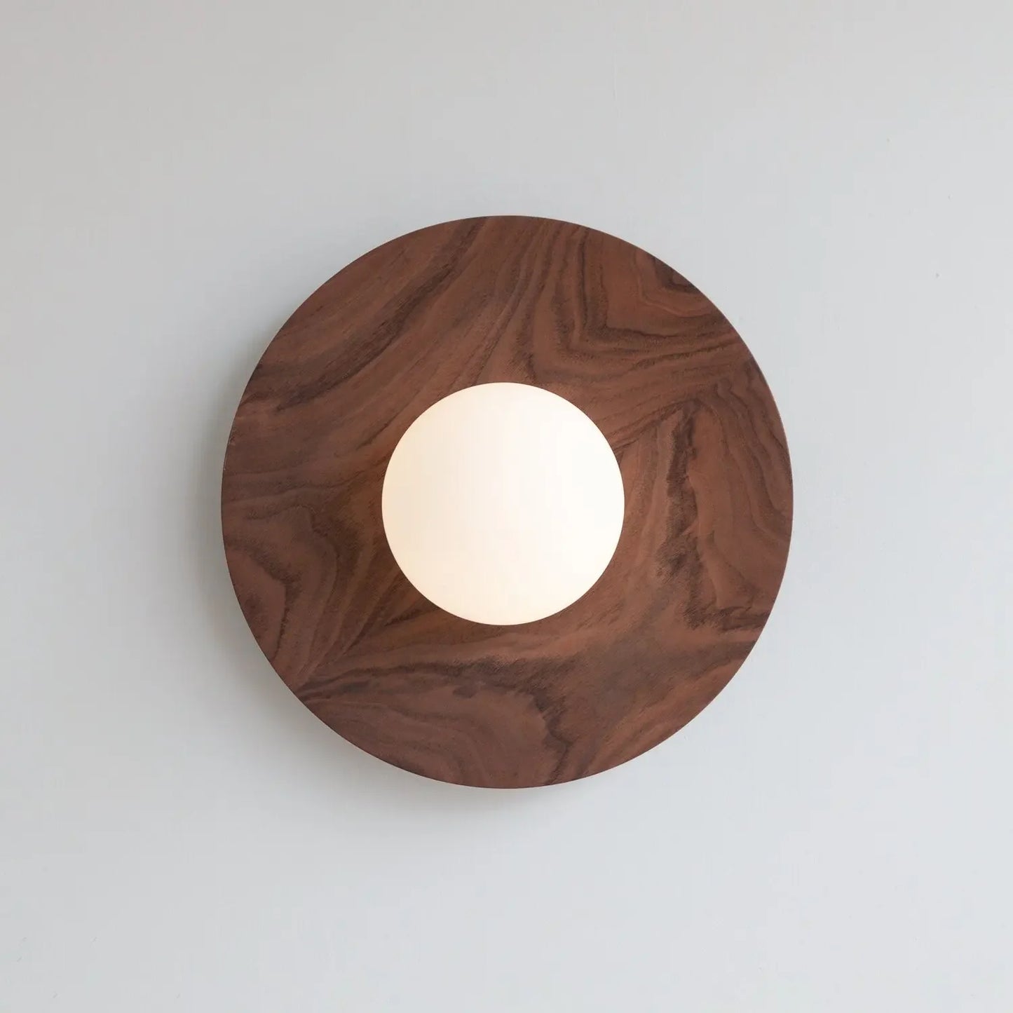 Wooden circular light fixture on a white background