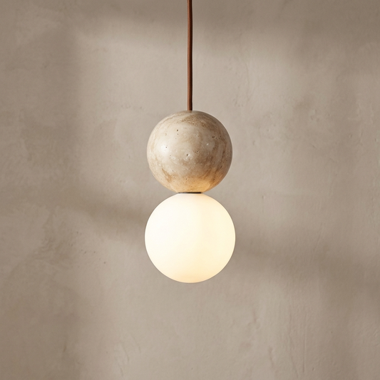 travertine Pendant light with two spherical designs against a beige wall