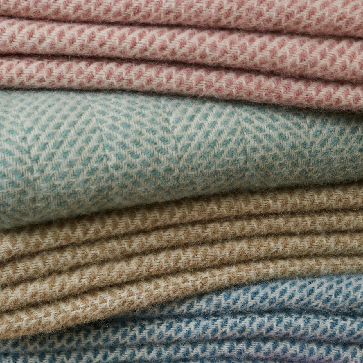 Stack of folded throws in various colors