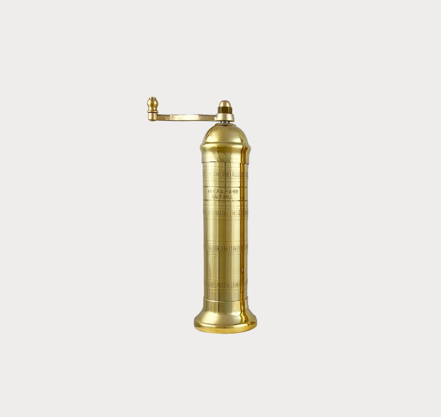 brass salt mill grinder on a white background