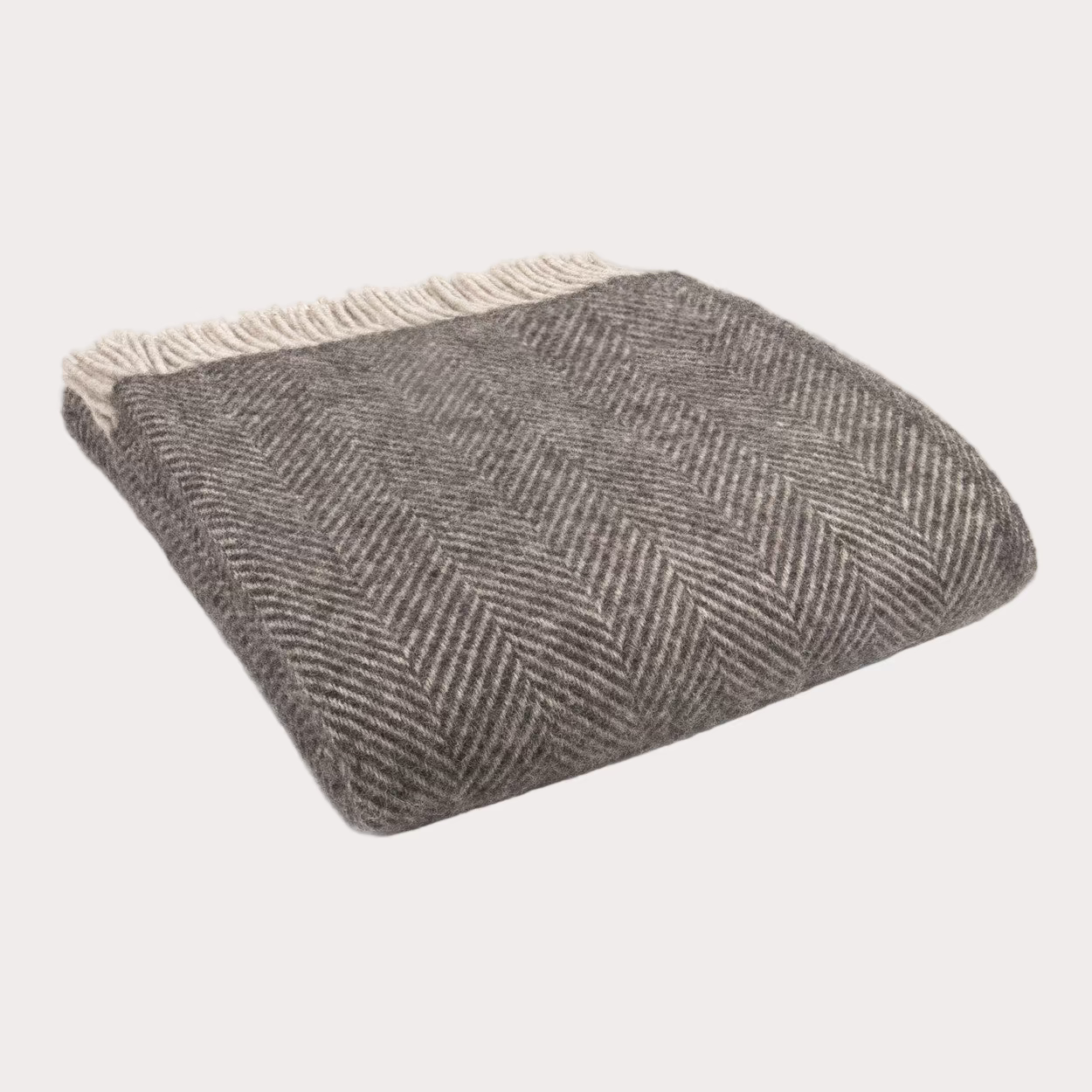 Grey herringbone patterned throw blanket on a white background