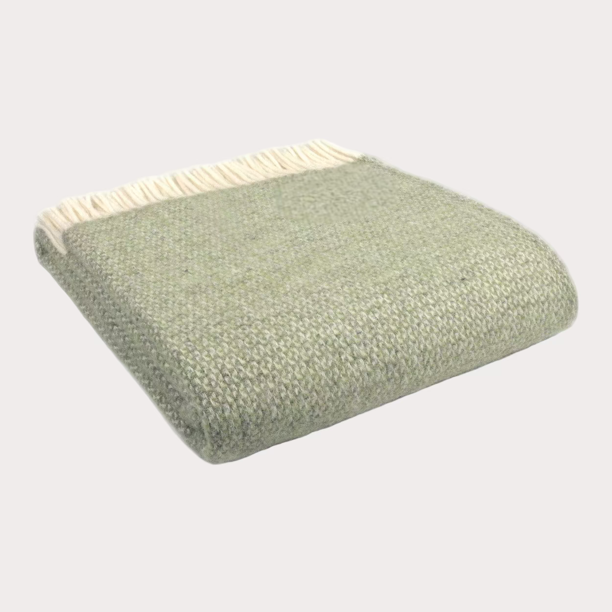 Green textured throw blanket with beige border on a white background