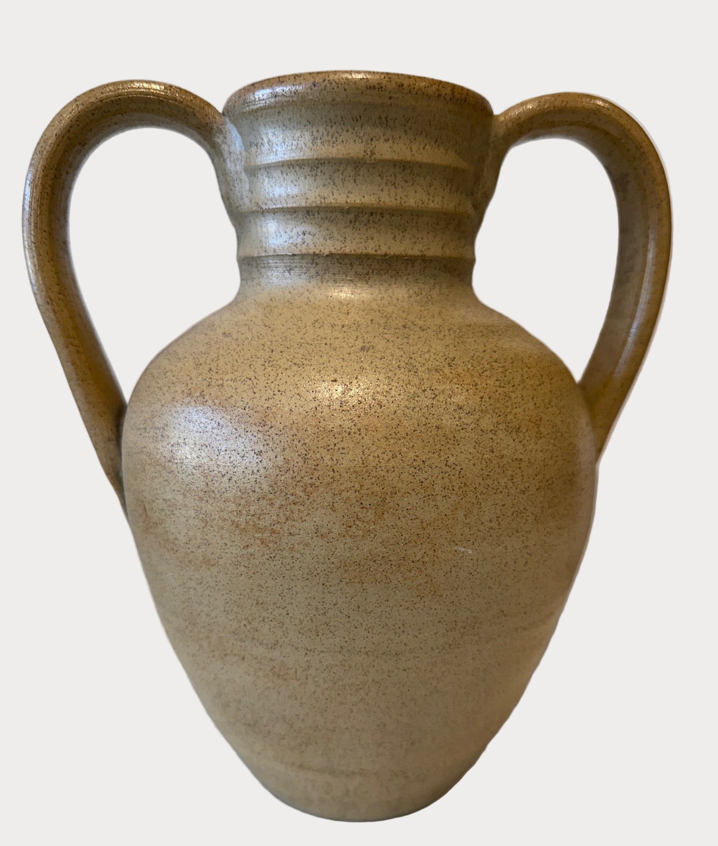 Beige ceramic vase with handles on a beige background