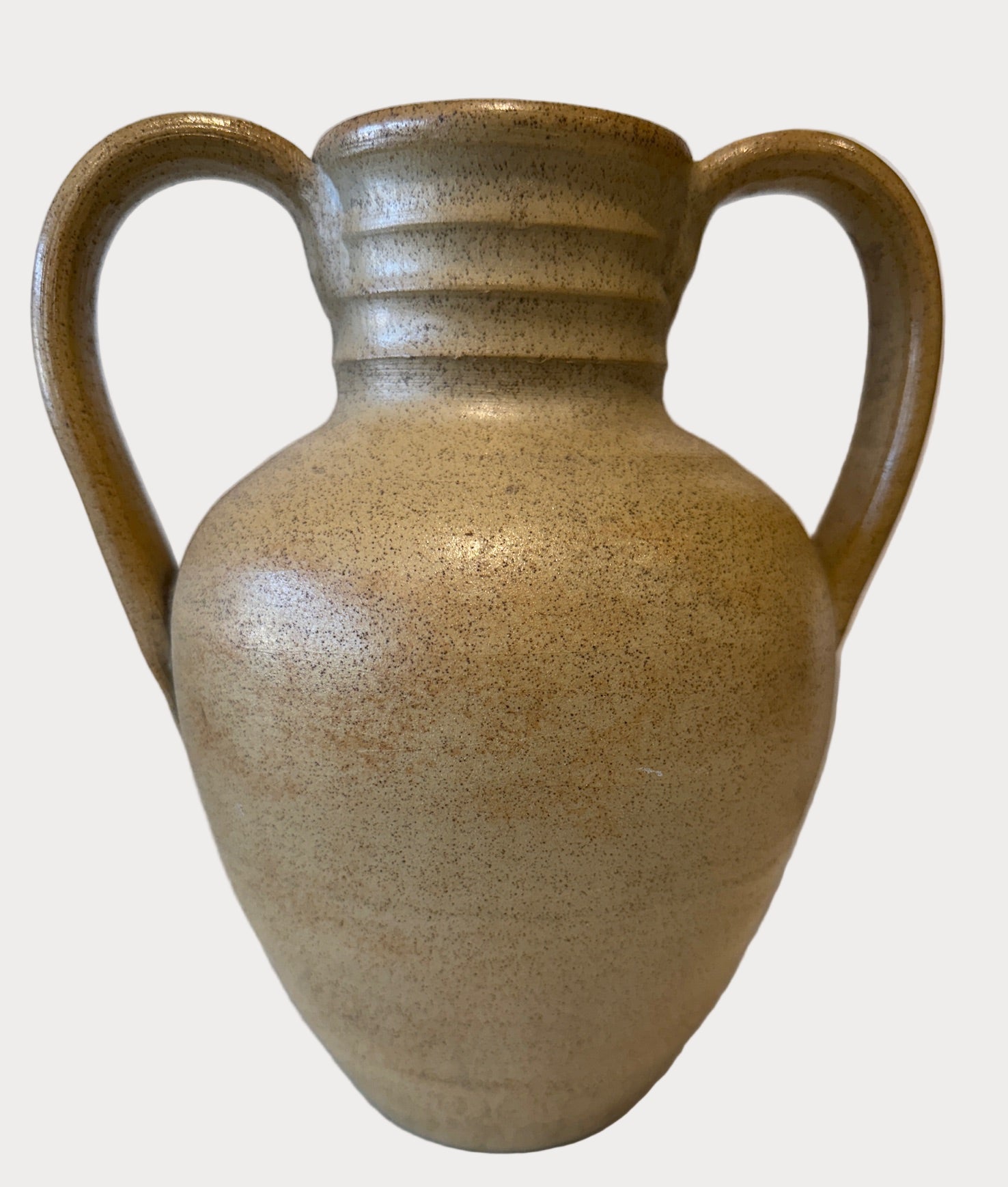 Beige ceramic vase with handles on a beige background