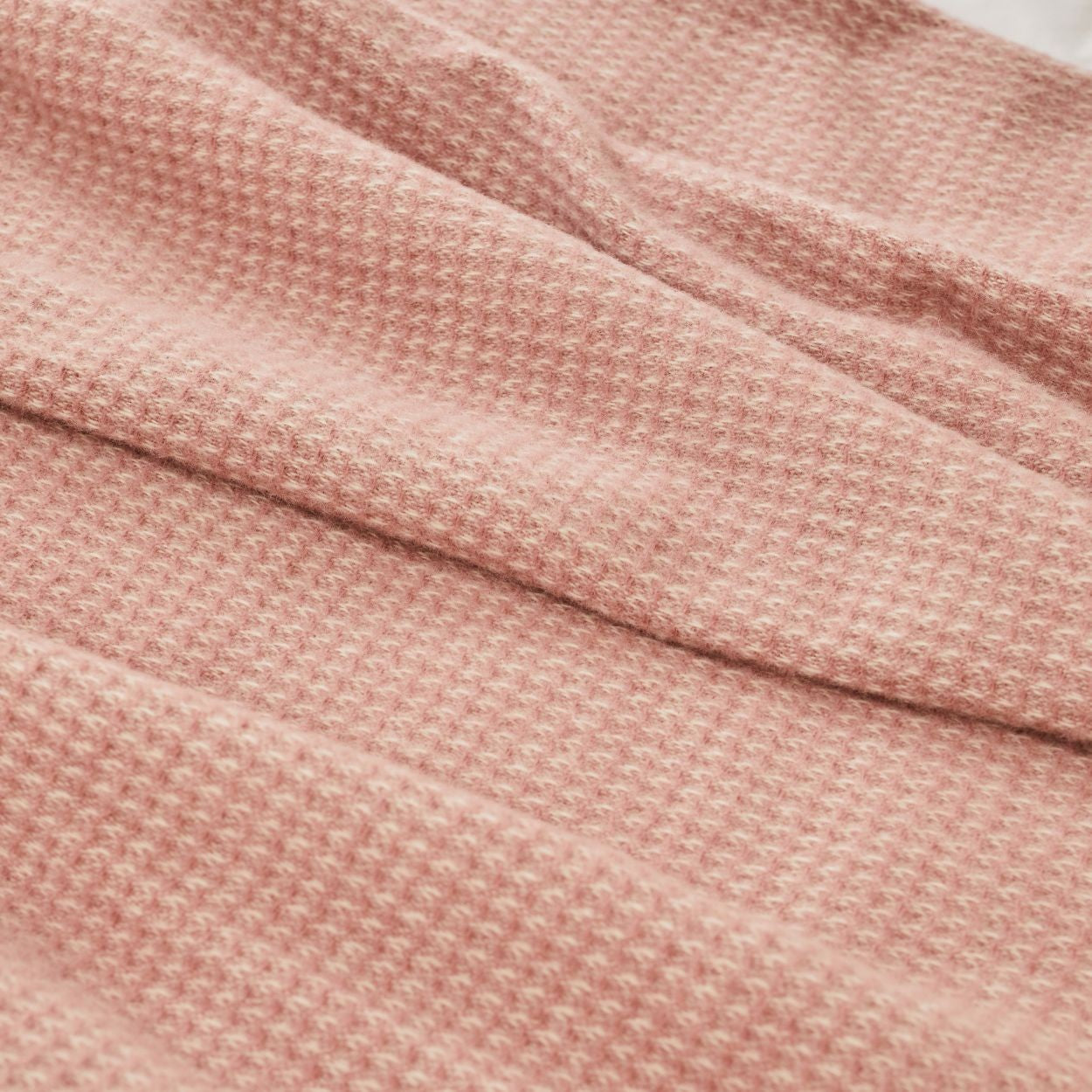 Close-up of Haworth Waffle throw blanket in dusky pink textured fabric