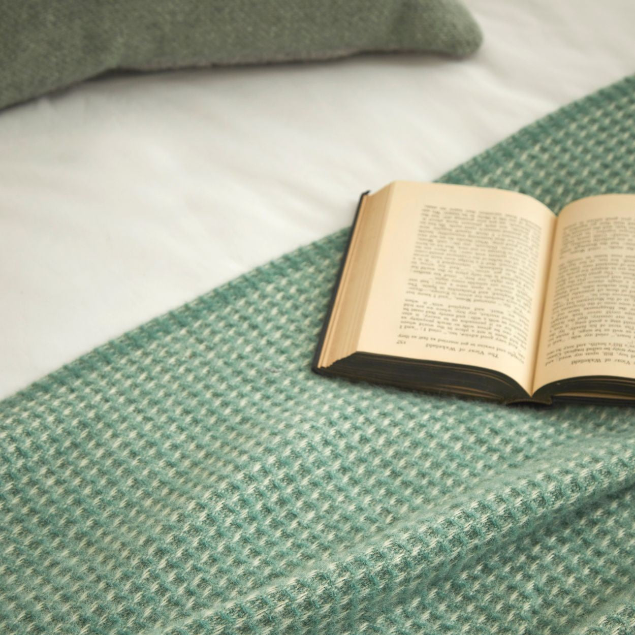waffle sea green throw close up pure british new wool blanket on bedding